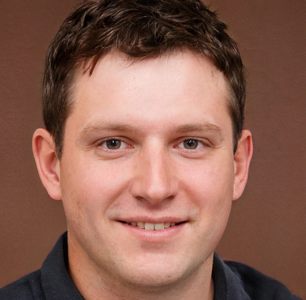 Close-up portrait of a smiling young man representing adult therapy for men clients seeking mental health care.
