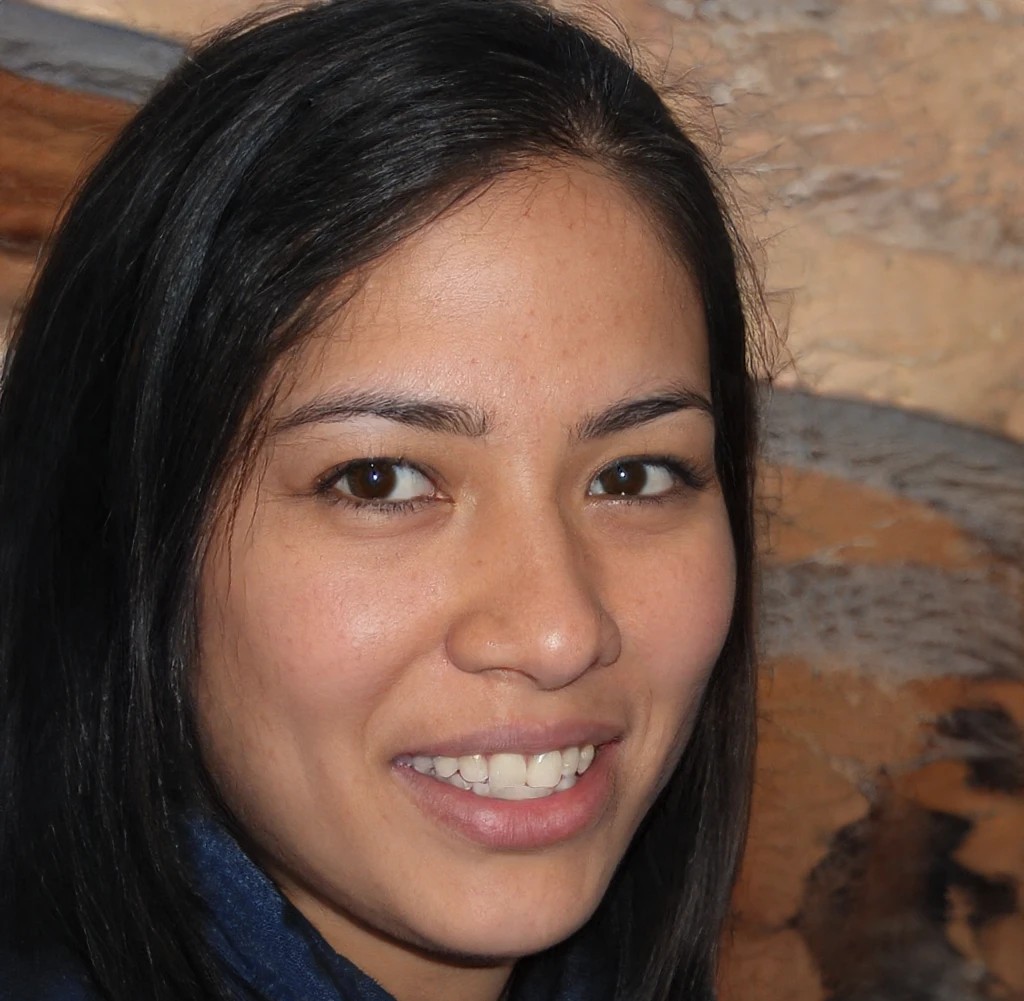 Smiling portrait of a woman with dark hair representing an Adult therapy for women in Montclair Client profile.
