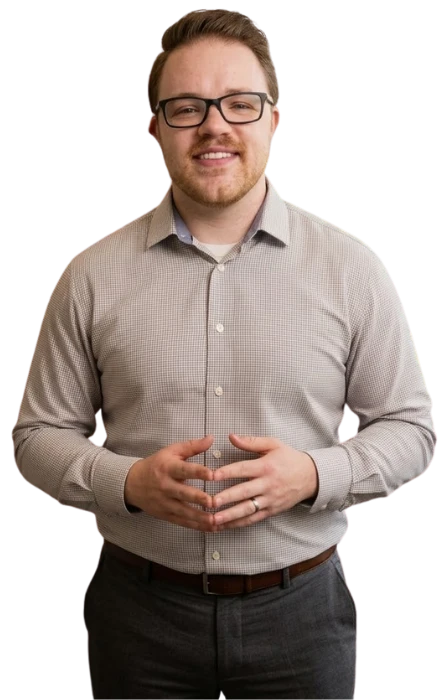 Portrait of a smiling man with glasses, serving as a Mental Wellness Montclair adult therapist for men professional.